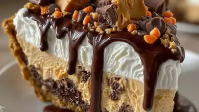 Giant Reese's Peanut Butter Cup Pie served on a plate with chocolate drizzle