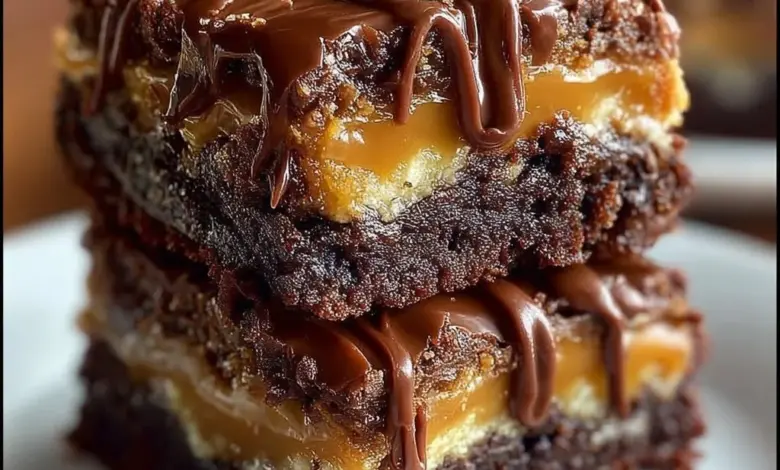 Delicious Snickers Brownie Bars topped with caramel and peanuts