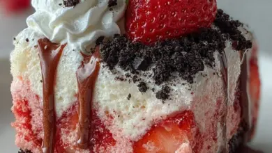 Strawberry cake with Oreo crumble topping on a white plate