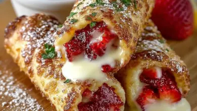 Strawberry cheesecake egg rolls with lemon glaze on a plate.