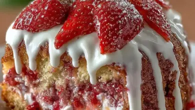 Slice of Strawberry Honeybun Cake with Strawberry Cream Icing on a plate